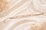 Celestial Harmony: Triple-Strand Rose Gold Beaded Bracelet